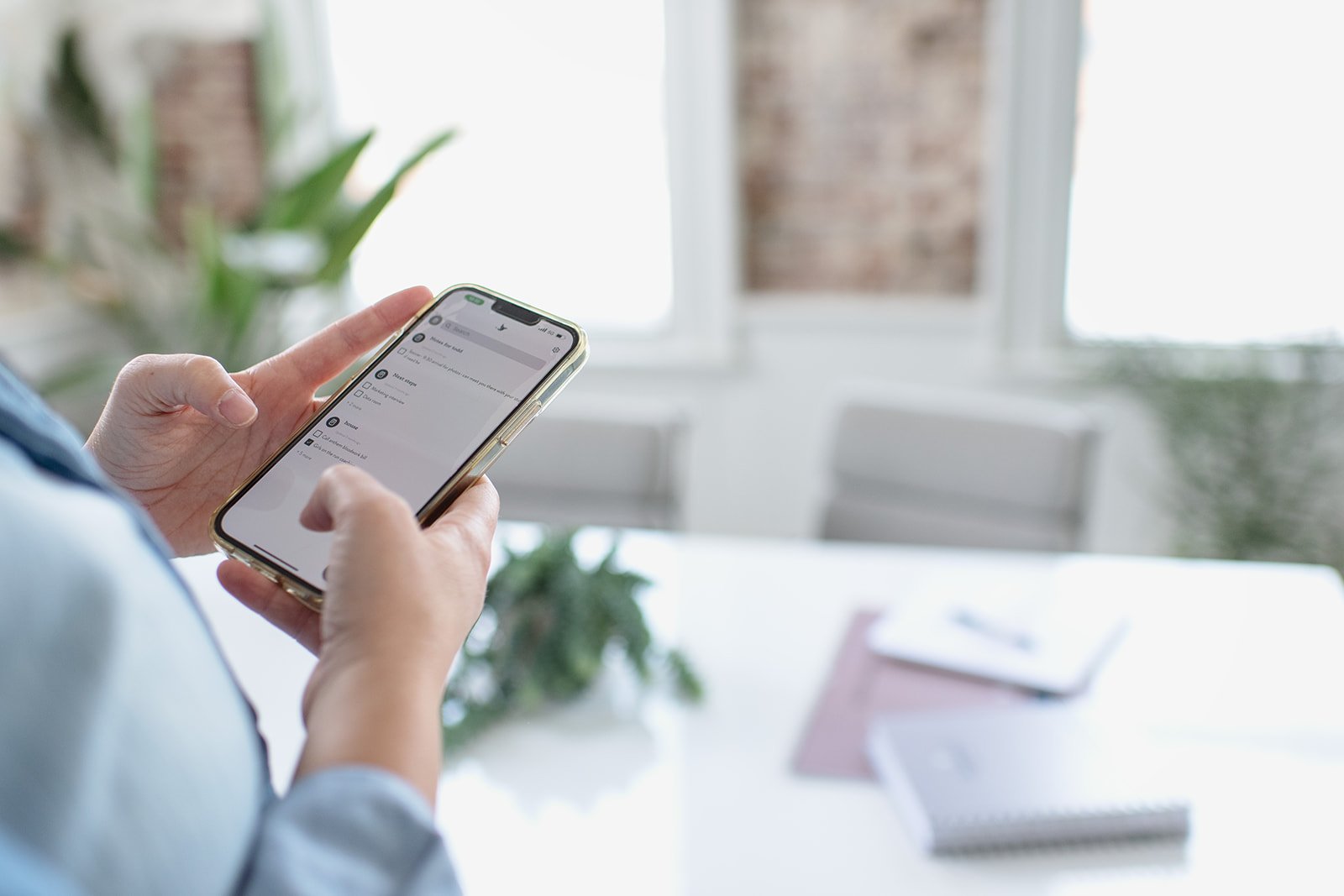 Person holding a phone looking at a screen.